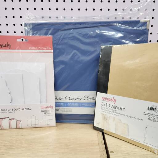 Scrapbooking and photo albums in different sizes for memory keeping and craft projects.